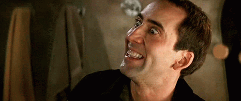A Close Up Of A Man 'S Face With His Mouth Open GIF