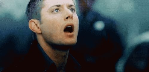 A Close Up Of A Man 'S Face With His Mouth Open Looking Up . GIF