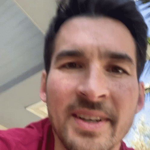 A Close Up Of A Man 'S Face With His Mouth Open GIF