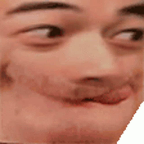 A Close Up Of A Man 'S Face With His Tongue Out And A Smile On His Face . GIF