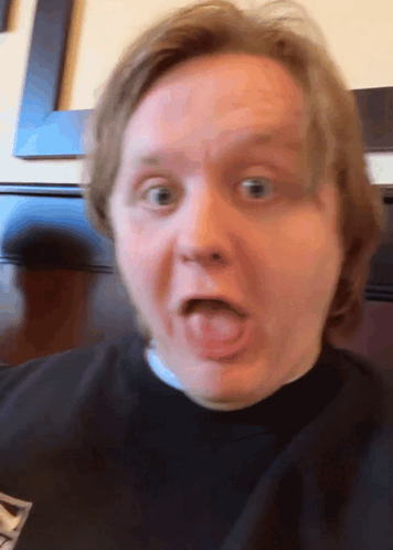 A Close Up Of A Man 'S Face With His Tongue Out GIF