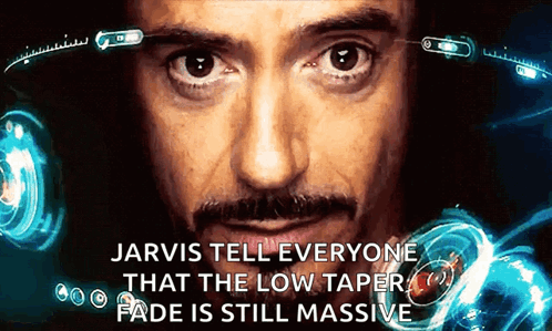 A Close Up Of A Man 'S Face With Jarvis Telling Everyone The Low Taper Fade Is Still Massive GIF