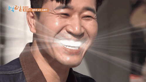 A Close Up Of A Man 'S Face With Korean Writing On The Bottom GIF
