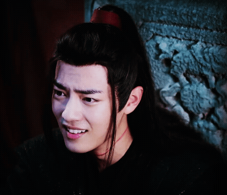 A Close Up Of A Man 'S Face With Long Black Hair GIF