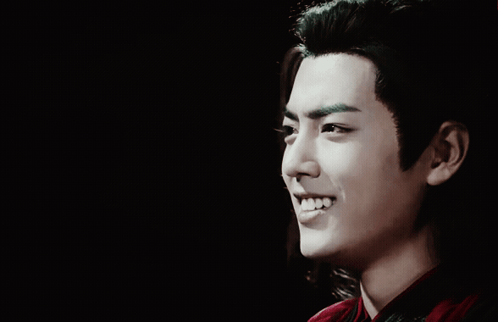 A Close Up Of A Man 'S Face With Long Hair GIF