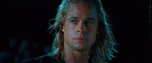 A Close Up Of A Man 'S Face With Long Hair And Blue Eyes . GIF