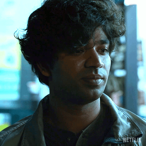 A Close Up Of A Man 'S Face With Netflix Written On His Jacket GIF