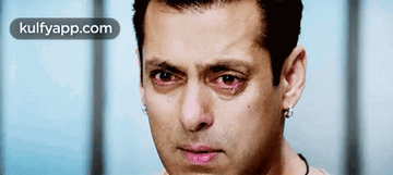 A Close Up Of A Man 'S Face With Red Eyes And The Words Kulfyapp.com Below Him GIF