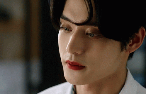 A Close Up Of A Man 'S Face With Red Lips GIF
