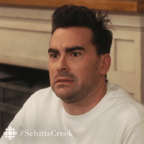 A Close Up Of A Man 'S Face With #Schitts Creek On The Bottom GIF