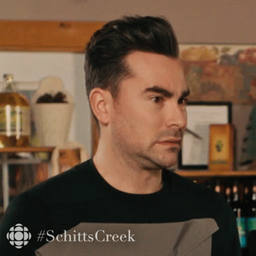 A Close Up Of A Man 'S Face With #Schitts Creek Written On The Bottom Right GIF
