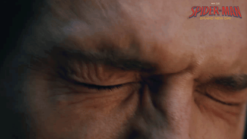 a close up of a man 's face with spider-man written on the bottom