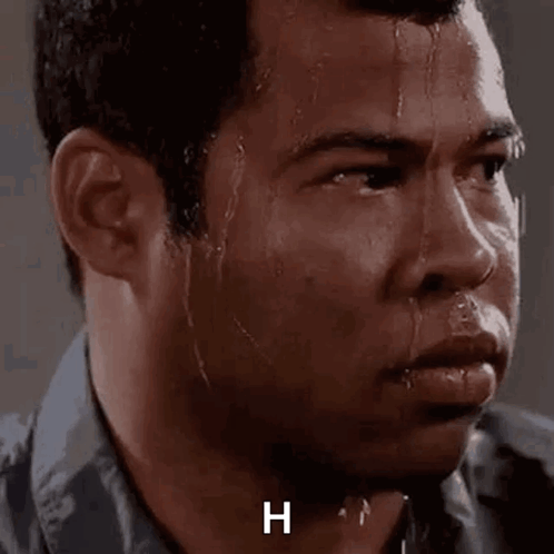 A Close Up Of A Man 'S Face With Sweat Coming Out Of His Face And The Letter H On The Bottom . GIF