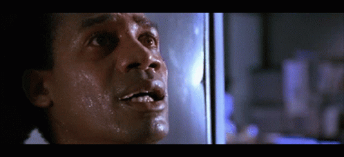 A Close Up Of A Man 'S Face With Sweat Coming Out Of His Mouth GIF