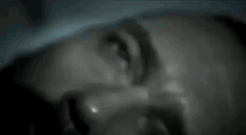 A Close Up Of A Man 'S Face With Sweat Coming Out Of It . GIF