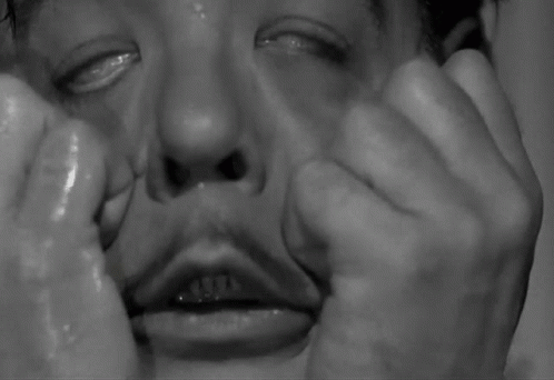 A Close Up Of A Man 'S Face With Tears Running Down His Face . GIF