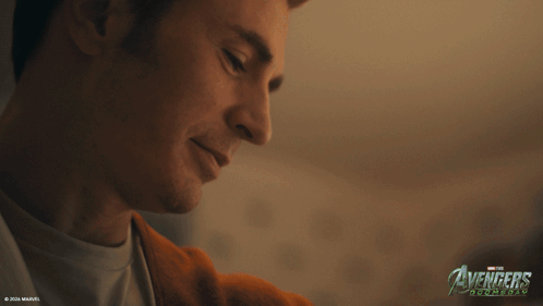 A Close Up Of A Man 'S Face With The Avengers Logo In The Corner GIF