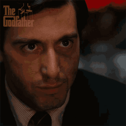 A Close Up Of A Man 'S Face With The Godfather Logo On The Bottom GIF