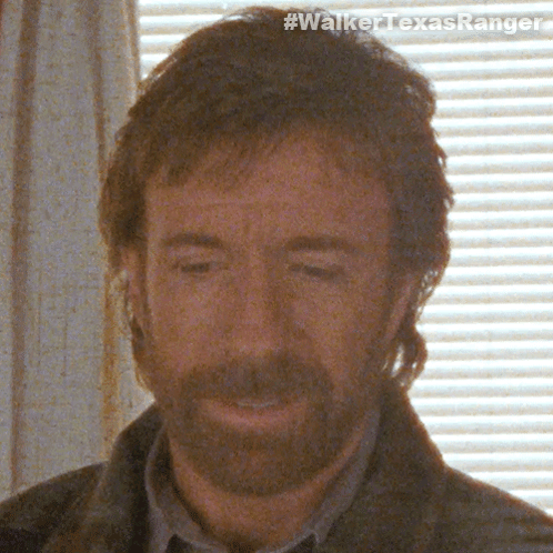 A Close Up Of A Man 'S Face With The Hashtag #Walkertexasranger Visible GIF