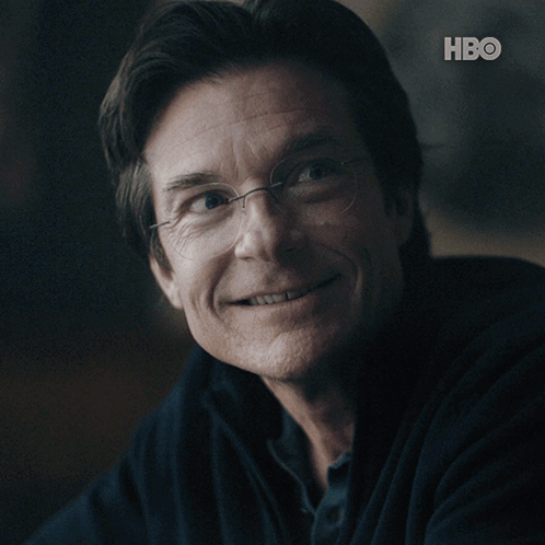 A Close Up Of A Man 'S Face With The Hbo Logo Behind Him GIF