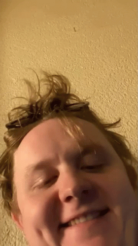 A Close Up Of A Man 'S Face With The Letter L In The Corner GIF