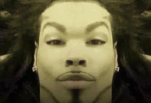 A Close Up Of A Man 'S Face With The Letter P On His Earring GIF