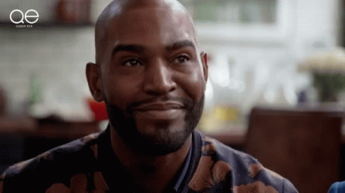 A Close Up Of A Man 'S Face With The Letters Oe Behind Him GIF