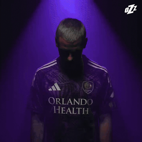 A Close Up Of A Man 'S Face With The Letters Ozz On His Head GIF
