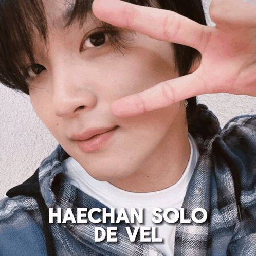 A Close Up Of A Man 'S Face With The Name Haechan Solo De Vel Written Above Him GIF