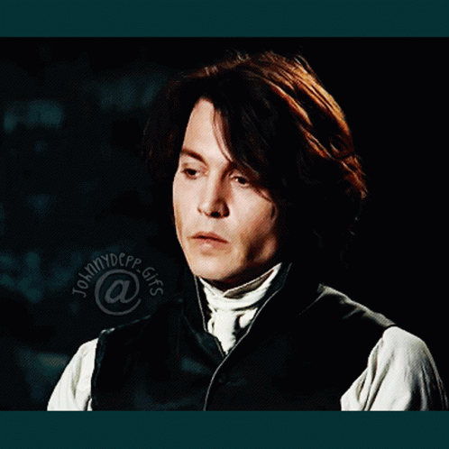 A Close Up Of A Man 'S Face With The Name Johnny Depp At The Bottom Of The Image GIF