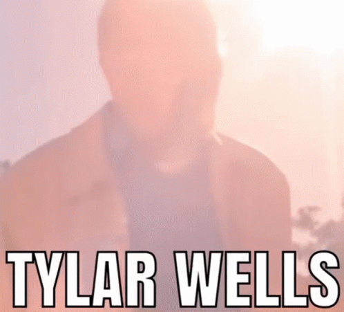 A Close Up Of A Man 'S Face With The Name Tylar Wells Written Above Him GIF