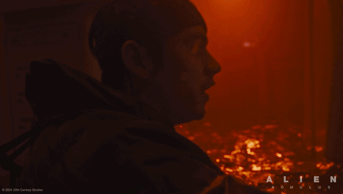 A Close Up Of A Man 'S Face With The Word Alien On The Bottom Right GIF