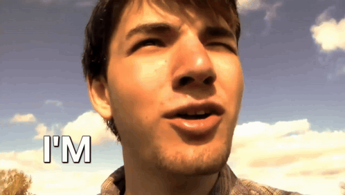 A Close Up Of A Man 'S Face With The Word I 'M Above Him GIF