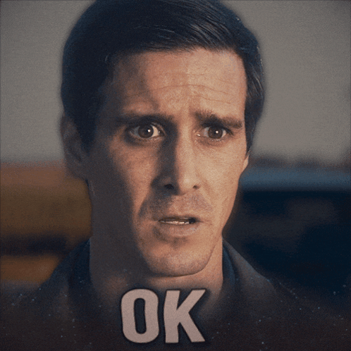 A Close Up Of A Man 'S Face With The Word Ok On His Face GIF