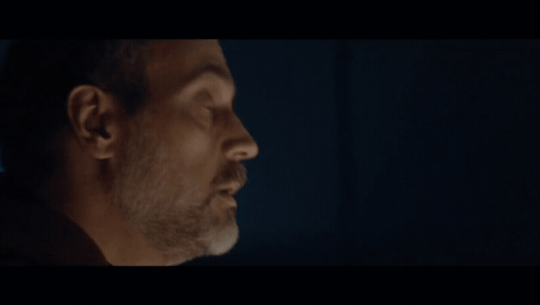 A Close Up Of A Man 'S Face With The Word Request Behind Him GIF