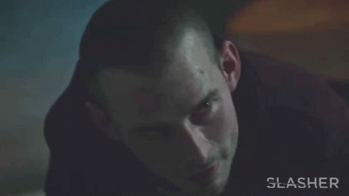 A Close Up Of A Man 'S Face With The Word Slasher On The Bottom Right GIF