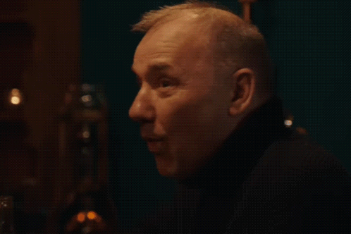 A Close Up Of A Man 'S Face With The Word Whoa Written In White GIF