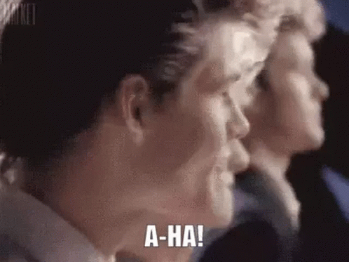 A Close Up Of A Man 'S Face With The Words `` A-Ha '' Written On His Face . GIF