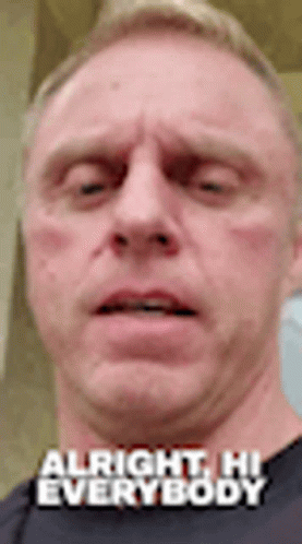 A Close Up Of A Man 'S Face With The Words `` Alright , Hi Everybody '' . GIF