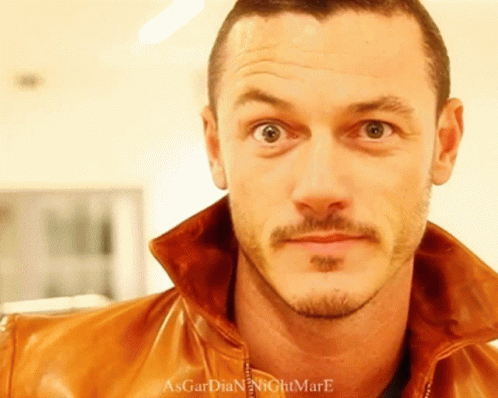 A Close Up Of A Man 'S Face With The Words Asgardian Nightmare Written On The Bottom GIF