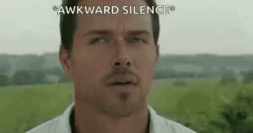 A Close Up Of A Man 'S Face With The Words `` Awkward Silence '' Written On The Bottom . GIF