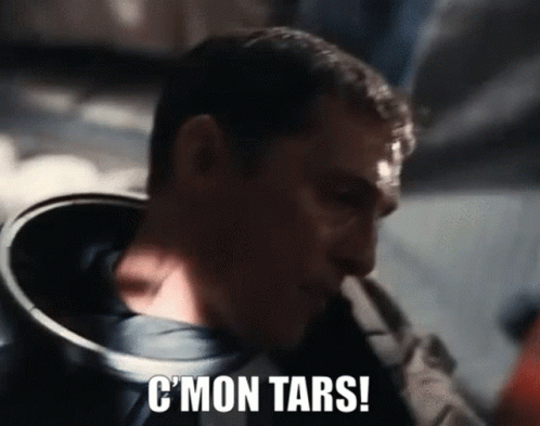 A Close Up Of A Man 'S Face With The Words C ' Mon Tars Written On It . GIF