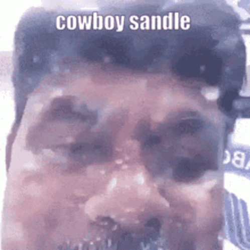 A Close Up Of A Man 'S Face With The Words Cowboy Sandle Written On It . GIF