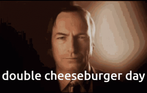 A Close Up Of A Man 'S Face With The Words Double Cheeseburger Day Above Him GIF