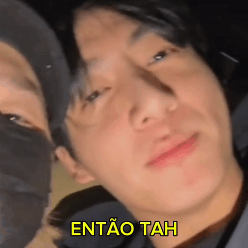 a close up of a man 's face with the words entao tah written above him