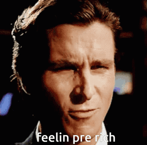 A Close Up Of A Man 'S Face With The Words Feelin Pre Rich Written Below It GIF