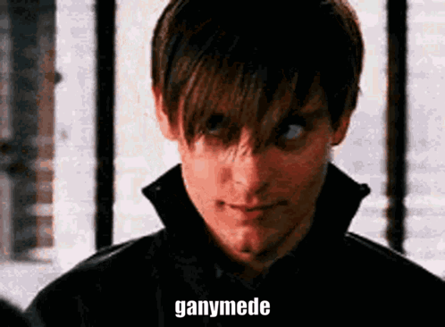 A Close Up Of A Man 'S Face With The Words Ganymede Written On His Face . GIF