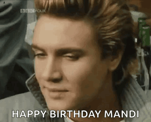 A Close Up Of A Man 'S Face With The Words Happy Birthday Mandi Above Him GIF