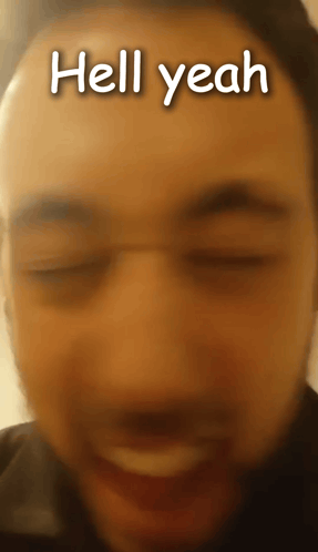 A Close Up Of A Man 'S Face With The Words Hell Yeah Written On It GIF