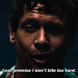 A Close Up Of A Man 'S Face With The Words " I Can Promise I Won 'T Bite Too Hard " GIF